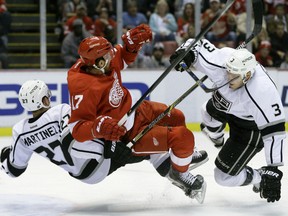 Detroit Red Wings center Brad Richards (17) collides with Los Angeles Kings defensemen Alec Martinez (27) and Brayden McNabb (3) in front of the net during the second period of an NHL hockey game, Friday, Nov. 20, 2015, in Detroit. (AP Photo/Carlos Osorio)