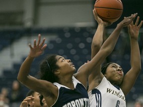 Windsor's Tyra Blizzard takes a shot while being defended by Toronto's Diedre Edwards during OUA women's basketball between the Windsor Lancers and the visiting Toronto Varsity Blues at the St. Denis Centre, Saturday, Nov. 21, 2015.