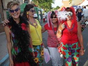 Dressed for the event, Doreen Beaudoin, left, Diana Slyzuk, Marie McLean and Betty Peltier join the Mardi Gras Street Party in downtown Amherstburg, Friday, July 24, 2015.