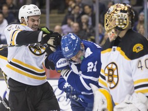 Boston Bruins Adam McQuaid (left) clashes with Toronto Maple Leafs James van Riemsdyk as Bruins goaltender Tuuka Rask looks on during second period NHL hockey action in Toronto on Monday, November 23, 2015. THE CANADIAN PRESS/Chris Young