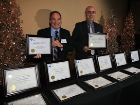 Mike Ouellette, left, and Robert Cattle, both of Canadian Tooling and Machining Association, prepare some of the 24 diplomas for graduates in the Introductory Trades Training Program November 25, 2015. The ceremony was held at the Ciociaro Club of Windsor.