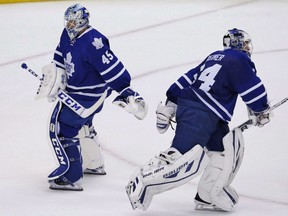 Toronto Maple Leafs goalie Jonathan Bernier, left, replaces James Reimer against the Ottawa Senators during second period NHL hockey action in Toronto, Saturday October 5, 2013. The Maple Leafs may have to go back to Jonathan Bernier in net, and not by design. Reimer, who has started 11 of the past 12 games for Toronto, left halfway through Tuesday's 45-minute practice with an undisclosed injury. THE CANADIAN PRESS/Mark Blinch