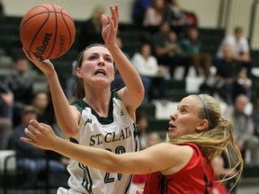 The St. Clair Saints Jaide Lyons drives around the Fanshawe Falcons Ali Vlasman at the SportsPlex in Windsor on Wednesday, November 25, 2015.                                                    (TYLER BROWNBRIDGE/The Windsor Star)