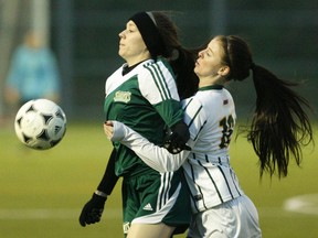Fleming Knights' Tori White, right, moves in on St. Clair Saints' Tiffany Trembley during the opening game of the 2015 OCAA women's soccer championship f on Thursday October 29, 2015 at Fleming Sports Field Complex in Peterborough, Ont. Clifford Skarstedt/Peterborough Examiner/Postmedia Network