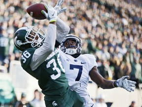 Windsor's Arjen Colquhoun #36 of the Michigan State Spartans makes an interception in the end zone of a pass intended for Geno Lewis #7 of the Penn State Nittany Lions in the first half of the game at Spartan Stadium on November 28, 2015 in East Lansing, Michigan. (Photo by Joe Robbins/Getty Images)