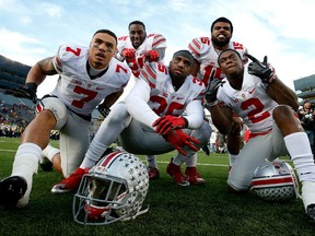 Ezekiel Elliott #15, Bri'onte Dunn #25, Jalin Marshall #7, Chris Worley #35 and Dontre Wilson #2 of the Ohio State Buckeyes celebrate a 42-13 win over the Michigan Wolverines at Michigan Stadium on November 28, 2015 in Ann Arbor, Michigan.  (Photo by Gregory Shamus/Getty Images)
