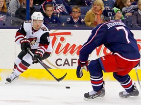 Max Domi #16 of the Arizona Coyotes attempts to skate the puck past Jack Johnson #7 of the Columbus Blue Jackets during the third period on November 14, 2015 at Nationwide Arena in Columbus, Ohio. Columbus defeated Arizona 5-2. (Photo by Kirk Irwin/Getty Images)