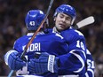 Toronto Maple Leafs' Nazem Kadri, left, congratulates teammate Joffrey Lupul on his second goal against the Dallas Stars during second period NHL hockey action in Toronto, Nov. 2, 2015.