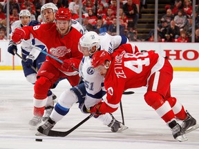 Valtteri Filppula #51 of the Tampa Bay Lightning battles for the puck between Henrik Zetterberg #40 and Justin Abdelkader #8 of the Detroit Red Wings during the second period of Game Six of the Eastern Conference Quarterfinals during the 2015 NHL Stanley Cup Playoffs at Joe Louis Arena on April 27, 2015 in Detroit, Michigan. (Photo by Gregory Shamus/Getty Images)