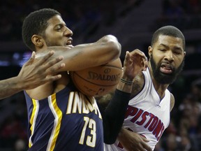 Indiana Pacers forward Paul George (13) drives to the basket as Detroit Pistons forward Marcus Morris defends during the first half of an NBA basketball game, Tuesday, Nov. 3, 2015, in Auburn Hills, Mich., (AP Photo/Carlos Osorio)