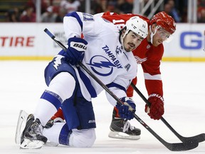 Tampa Bay Lightning center Brian Boyle (11) and Detroit Red Wings center Joakim Andersson (18) watch the puck after a face-off during the second period of an NHL hockey game Tuesday, Nov. 3, 2015 in Detroit. (AP Photo/Paul Sancya)