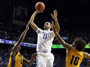 Windsor's Mychal Mulder, centre, was taken in the first round of the NBA G League by Windy City on Saturday.
