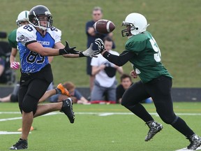 Tecumseh Vista's Oscar Fratarcangeli hauls in a pass as Belle River linebacker Connor Sykes defends during the senior boys high school football game in Tecumseh on Nov. 5, 2015.