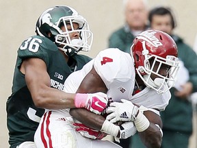 Windsor's Arjen Colquhoun #36 of the Michigan State Spartans wraps up Ricky Jones #4 of the Indiana Hoosiers during the first half at Spartan Stadium on October 24, 2015 in East Lansing, Michigan. (Photo by Duane Burleson/Getty Images)