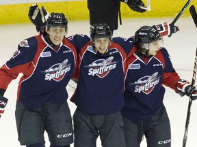 Windsor Spitfires forward Markus Soberg, middle, celebrates his goal against the London Knights with teammates Logan Stanley, left, and Cole Carter, right, during their OHL hockey game at Budweiser Gardens in London, Ont. on Friday October 30, 2015. Craig Glover/The London Free Press/Postmedia Network