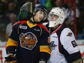 Erie Otters Jake Marchment gets a hug from Windsor Spitfires goaltender Michael Giugovaz in the Ontario Hockey League opening game at the WFCU Centre in Windsor, Ontario on September 24, 2015. (JASON KRYK/The Windsor Star)