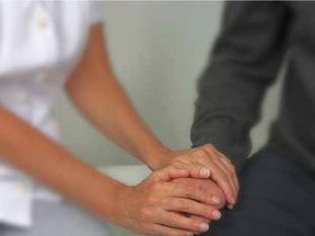 A nurse comforts a patient. (Fotolia.com)