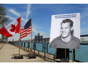 A photograph of Gordie Howe is displayed on the riverfront after a news conference, Thursday, May 14, 2015, in Windsor, Ontario, announcing that a planned bridge connecting Detroit, rear, and Windsor, will be named after the hockey Hall of Famer. The yet-to-be built Gordie Howe International Bridge is expected to be operational in 2020.