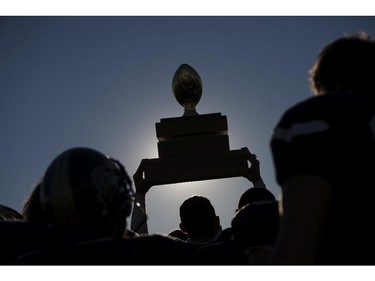 The AKO Fratmen hoist the championship trophy into the air after defeating the Ottawa Sooners 21-11 in the Ontario Football Conference championship game at E.J. Lajeunesse, Sunday, Nov. 1, 2015.  (DAX MELMER/The Windsor Star)