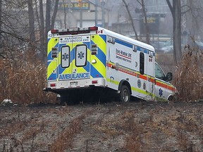 An Essex-Windsor EMS ambulance remains in a field along Ojibway Parkway near Sprucewood Avenue at the Windsor - LaSalle border on Friday, Nov. 27, 2015.  The ambulance was involved in an accident that closed the parkway for the entire day.