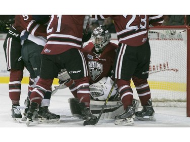 Guelph goaltender Justin Nichols is surrounded by a scrum of players after making a save in the second period of OHL action between the Windsor Spitfires and the Guelph Storm at the WFCU Centre, Saturday, Oct. 31, 2015.   (DAX MELMER/The Windsor Star)