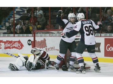 Windsor's Aaron luchuk and Cristiano DiGiacinto celebrate after a Spitfire goal while Guelph goaltender, Justin Nichols, lays on his back in the second period of OHL action between the Windsor Spitfires and the Guelph Storm at the WFCU Centre, Saturday, Oct. 31, 2015.   (DAX MELMER/The Windsor Star)