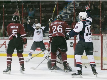 Windsor's Bradley Latour, left, and Christian Fischer celebrate a second period Spitfire goal while  Guelph's C.J. Garcia and Nick Deakin-Poot look on during OHL action between the Windsor Spitfires and the Guelph Storm at the WFCU Centre, Saturday, Oct. 31, 2015.   (DAX MELMER/The Windsor Star)
