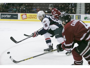 Windsor's Christian DiGiacinto battles for the puck with Guelph's Noah Carrol during OHL action between the Windsor Spitfires and the Guelph Storm at the WFCU Centre, Saturday, Oct. 31, 2015.   (DAX MELMER/The Windsor Star)