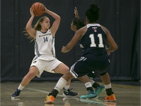 WINDSOR, ON.: NOVEMEBER 21, 2015 -- Windsor's Kaylee Anagnostopoulos, left, looks to pass while being defended by Toronto's Diedre Edwards and Abena Addo during OUA women's basketball between the Windsor Lancers and the visiting Toronto Varsity Blues at the St. Denis Centre, Saturday, Nov. 21, 2015.  (DAX MELMER/The Windsor Star)