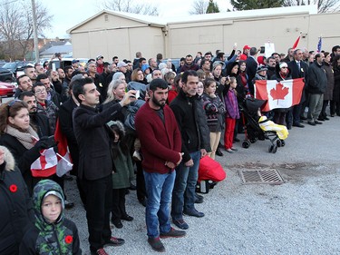 Members of the Blenheim community watch as the Highway of Heroes procession for John Gallagher arrives in downtown Blenheim, Ontario on November 20, 2015.  Gallagher was kills fighting ISIS in Syria.