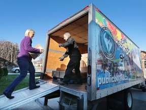 A total of 12,647 books were collected for the Links to Literacy Children's Book Drive in LaSalle, ON. The books were picked up on Friday, November 20, 2015, and will be given to nearby locations of the Ontario Early Years Centres and the remaining books will be going to 13 selected schools in the Greater Essex County District School Board. Tamye Machina, drive organizer carries a box a books to Kim Delaurier, a courier with the school board. (DAN JANISSE/The Windsor Star)