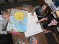 H.J. Lassaline Catholic Elementary School students, from left, Benjamin McKinley, Alexandra Banjavcic,  and Alyssa Campbell work on anti-bullying posters at the school on Friday, November 13, 2015.