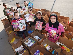 Ecole Bellewood students,  Kayleigh Lachapelle Jake Schincariol, Carmen Castro,  Adelene Pang,  Maryum Ajaz,  Ali Mollahassani,  Anamta Masoodi , Joshua Mathews display hundreds of boxes of cereal that have been donated to 13th annual Cereal Drive.   There were over 2 million grams of cereal (2,029,900 grams to be more precise) collected in 233 giant leaf bags by 6 participating schools. Mad Science has donated a free presentation to the school with the highest grams per student average. Sharp Bus Company and Optimist Club members donate the buses and the drivers for transport.
