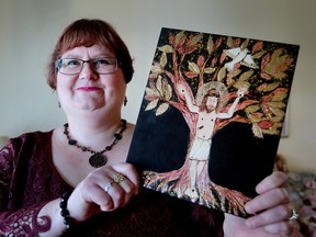 Deborah Kloos is shown at her Windsor, Ont., home on Monday, Nov. 9, 2015. Kloos was sexually abused by her parish priest as a teen. She is lobbying the Catholic Church to have an annual day of prayer for survivors like herself. She displays a piece of her artwork similar to the one that was presented to the Pope.