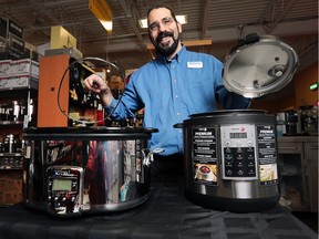 Joel Beneteau of Williams Food Equipment displays an All-Clad slow cooker ($225), left, and Fagor electric pressure cooker ($134.99) on Thursday, Nov. 19, 2015 in Windsor.