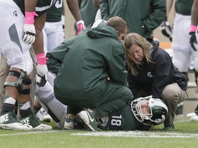 Michigan State quarterback Connor Cook is examined on the field during a game against Indiana, in East Lansing, Mich., in October. Cook said after the Ohio State game last weekend that he was having some pain in his right shoulder, so we'll see if he is ready to go against Penn State on Saturday.