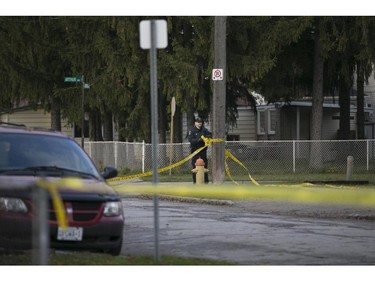A Windsor police officer takes down yellow tape at the intersection of Pillette Rd. and Ontario St., after a pedestrian was struck by a vehicle, Sunday, Nov. 1, 2015.  They are treating the incident as an attempted murder.  (DAX MELMER/The Windsor Star)