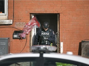 A Windsor police officer works at the scene of a pedestrian struck by a car at the intersection of Pillette Rd. and Ontario St., Sunday, Nov. 1, 2015.  They are treating the incident as an attempted murder.