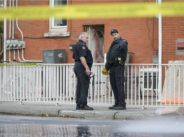 WINDSOR, ONT.: NOVEMBER 1, 2015 --  A Windsor police officer and a member of Windsor Fire and Rescue, left, work at the scene of a pedestrian struck by a car at the intersection of Pillette Rd. and Ontario St., Sunday, Nov. 1, 2015.  They are treating the incident as an attempted murder.  (DAX MELMER/The Windsor Star)