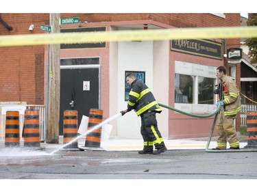 Firefighters with Windsor Fire and Rescue wash down the street at the intersection of Pillette Rd. and Ontario St. after a male was struck by a vehicle, Sunday, Nov. 1, 2015.  They are treating the incident as an attempted murder.  (DAX MELMER/The Windsor Star)