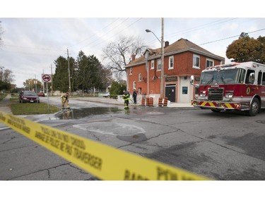 Windsor firemen wash down the road after the completion by Windsor Police of an attempted murder after a pedestrian was struck by a car at the intersection of Pillette Rd. and Ontario St., Sunday, Nov. 1, 2015.  (DAX MELMER/The Windsor Star)