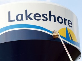 A worker paints the Lakeshore logo on a water tower in Lakeshore, Ont. in this file photo.