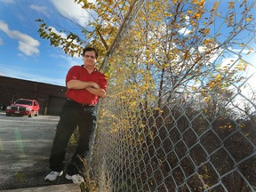 Jerry Stchyrba, owner of Crescent Electronics in Windsor, ON. poses next to an overgrown ditch near the Marentette Ave. business. He has been asking the city to groom the area for two years without success.