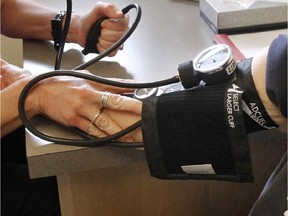 Files: A patient's blood pressure is checked by nurse. (Associated Press files)
