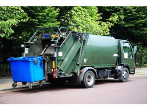 Garbage truck collecting garbage. Photo by fotolia.com.