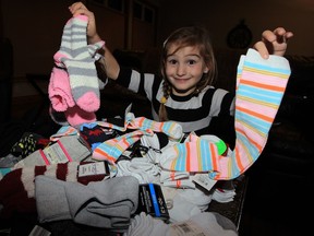 Kylie Costie, 7, has collected thousands of pairs of socks to be donated to area needy Monday November 16, 2015. "Socks are the least donated, but most needed," said Kylie.