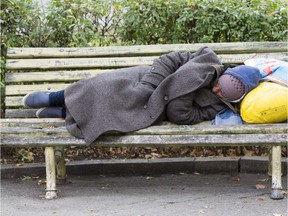 Homeless man sleeping on a bench. (Fotolia.com)