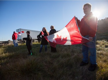 Hundreds of supporters line overpasses and off ramps near London, Ontario, Friday, November 20, 2015 as they await the procession for former Canadian soldier John Gallagher, who was killed while fighting against ISIS as a volunteer with the Kurdish YPG guerillas.