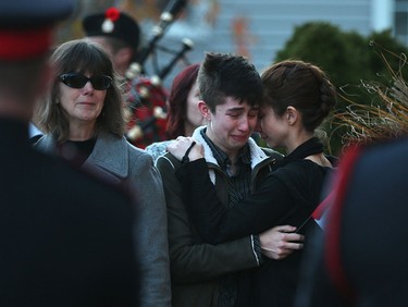 Family members  of John Gallagher cry as the Canadian soldier arrives in Blenheim, Ontario on November 20, 2015.  Gallagher was killed battling ISIS in Syria.  A procession travelled down the Highway of heroes from Toronto to Blenheim, Ontario.