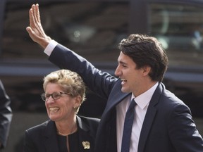 Canadian prime minister-designate Justin Trudeau is greeted by Ontario Premier Kathleen Wynne at the Queens Park Legislature in Toronto on Tuesday, October 27, 2015.